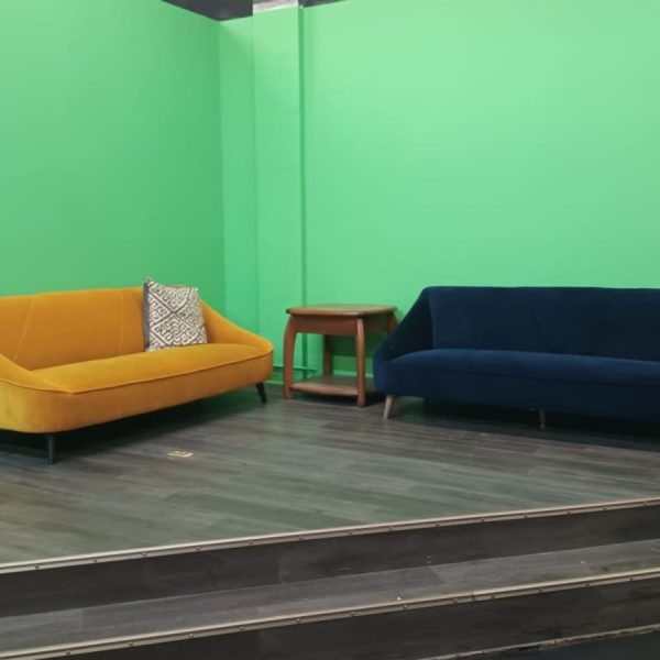 Yellow and navy sofas in the VYRE Live Studios lounge