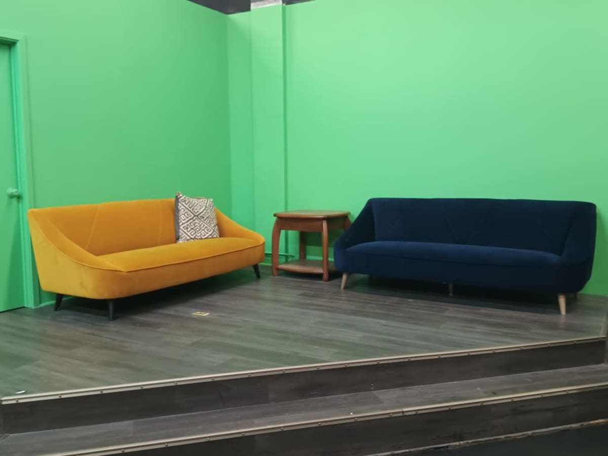 Yellow and navy sofas in the VYRE Live Studios lounge