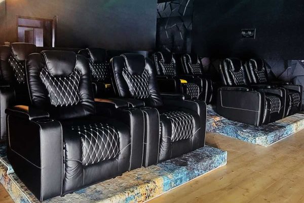 Black reclining seats inside the VYRE Live Studios private screening room