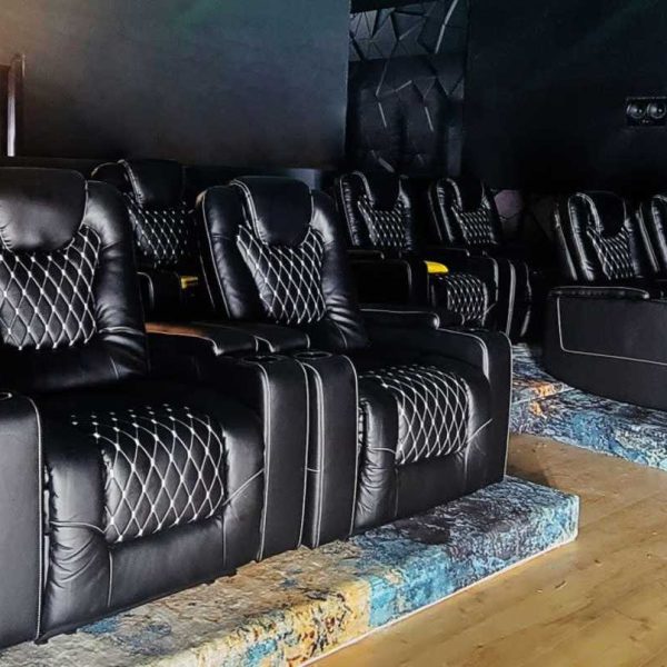 Black reclining seats inside the VYRE Live Studios private screening room